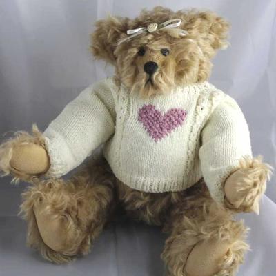 Evangeline-207.  White long sleeved hand knit  sweater with purple heart.  White head ribbon tied  with fabric flower and bow.  Signed on...