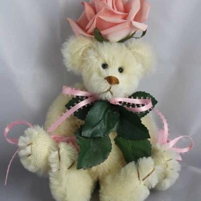 Miss Rosemary-45 Rose Bear.  She wears a pink rose  on her head with the green leaves extending from  her neck down her chest.  She has...
