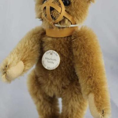 Steiff Teddy Bear - Teddy With Muzzle Mini-102 Mohair-It brown/flannel-It. tan.  Jtd. light brown  mohair bear wearing a beige leather...