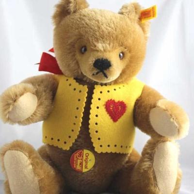 Luv Bear-er (Valentine)-580 Brown Bear.  Wears a  yellow felt vest decorated with a red embroidered  heart.  His neck bow is red silk....