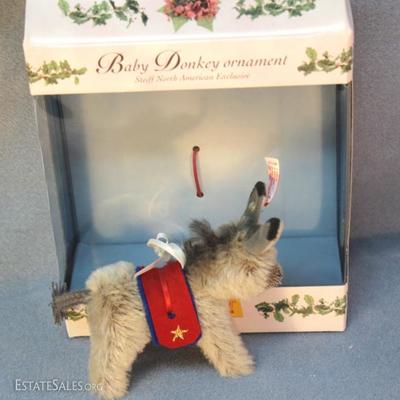 Steiff baby donkey Christmas ornament 717 in grey  mohair.  North American Exclusive.  This baby grey  donkey is wearing a red and blue...