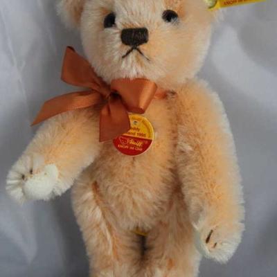 Teddy Holland 1955-345 Bow Tie Pink Bear.  Wears a  salmon ribbon neck bow.  Has a historic half red,  half yellow chest tag. Size:...