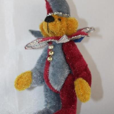 Jester Blue-199.  This Little Gem Teddy Bear  edition.  Burgundy/silver blue suit with matching  cap.  Wears a neckline ruffle. Size:  3