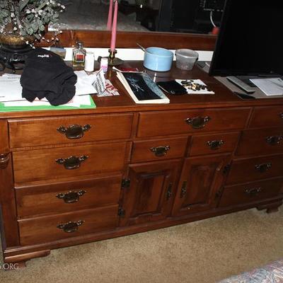 Dresser with mirror, TV, candlestick, floral arrangement, TV tray