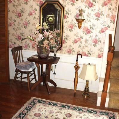 Antique table, chair, rug, lamp, mirror, floral arrangement