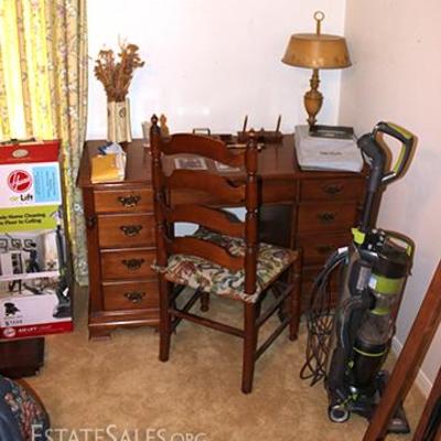 executive desk, ladder back chair, lamp,  vase, vacuum