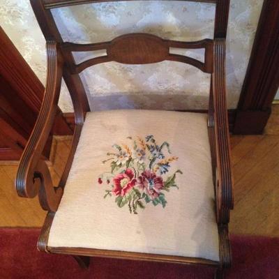 Dining chairs all upholstered with different floral designed chairs on same base cream color needlepoint