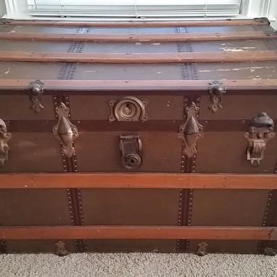 Antique chest with leather handles and wood accents. $100.00