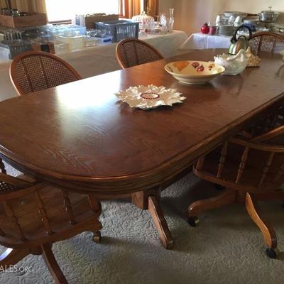 100-inch dining room table with six captain's chairs.