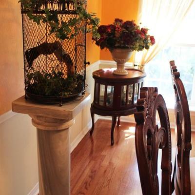 Marble pedestal, decorative bird cage, glass display side table, floral arrangement