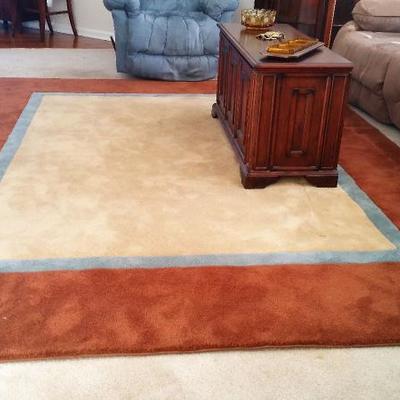 Nice area rug in beige, blue and rust.  Approximate size 8x10