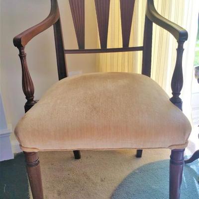 This chair is most unusual.  It is Walnut with carved wooden back and arms.  Very nice