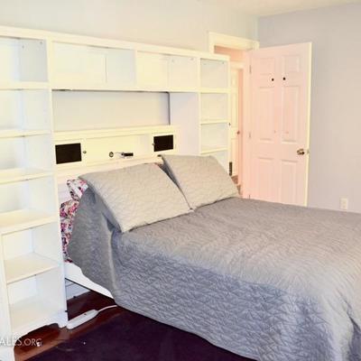Full bed with storage headboard and additional shelving