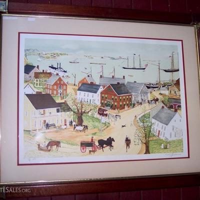 SIGNED WILL MOSES FOLK ART COLORED LITHOGRAPH OF TOWN BY THE OCEAN WITH CROOKED STEETS, HORSE DRAWN CARRIAGES AND TALL SHIPS IN THE...