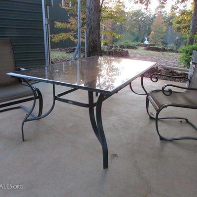 Glass top table w/4 chairs. Table has hole in center for an umbrella, umbrella not included