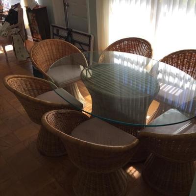 This is a really nice wicker dining room set. It is a neutral wicker â€“ not painted â€“ and the glass top is removable for moving. It...