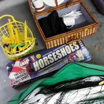 Box lot of outdoor game equipment, and picnic baskets , horseshoes game, outdoor volleyball net
