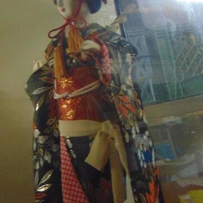 large Oriental doll in showcase