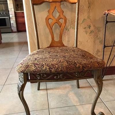 Heavy wood and metal upholstered chair used in kitchen desk area