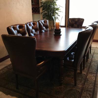 Formal dining table - fine quality walnut.  Has 8 leather chairs, 2 leaves and protective padding.