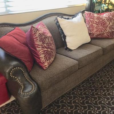 Up close of couch - leather and fabric with 4 pillows each ( living room ) 