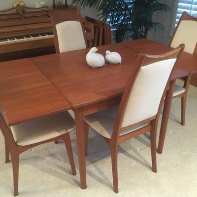 Lovely Danish modern TEAK dining set w/ four chairs. Breaks down to a small square table. Perfect for small spaces!