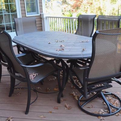Oblong stone patio table and 6 chairs