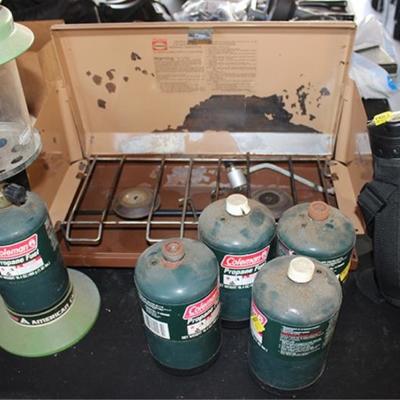 Coleman lantern, gas grill, canteen
