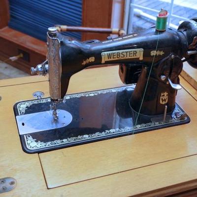 Vintage Webster sewing machine in cabinet
