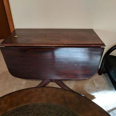 Antique drop leaf table. has an issue with one leg