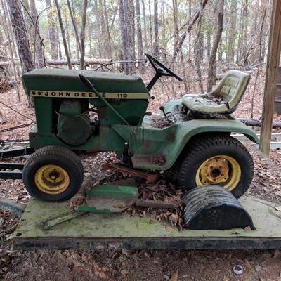John Deere 110 Garden Tractor with trailer 
Comes with a front end loader and some implements 