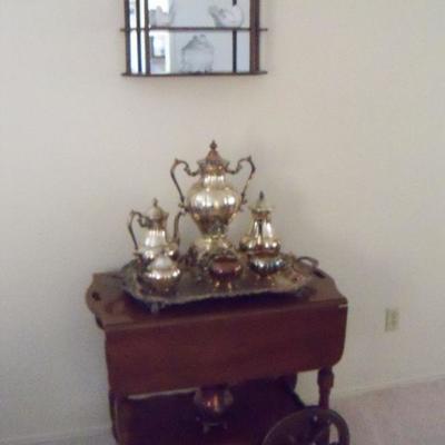 Tea cart and silver serving coffee and tea set with tray.