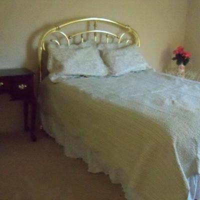 Queen size bed with pillow top mattress and Brass headboard
