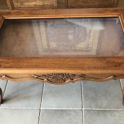 coffee table with glass covered shadow box display area for collections