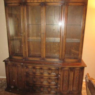 Vintage wooden buffet with glass shelving and doors in the china cabinet
