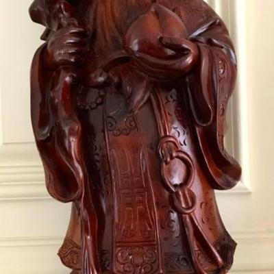 set of three hand carved wood figures of healthy, happy, and wealth
