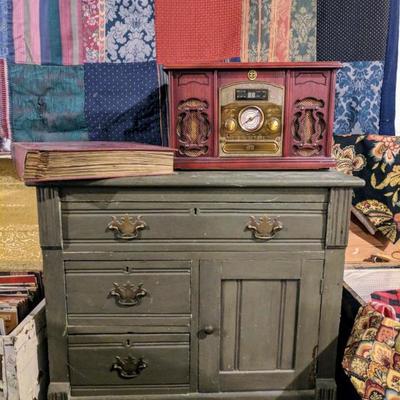 Vintage desk, record player/radio, and wall hanging