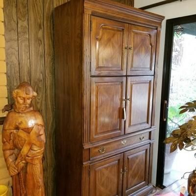 Armoire storage closet plus a 4 foot hand carved saint 