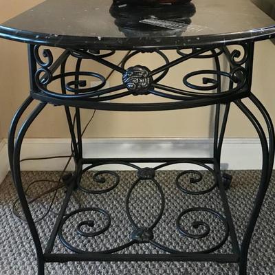 There are 2 of these unique rod iron based tables. They each have stone tops with fossils in the stone.