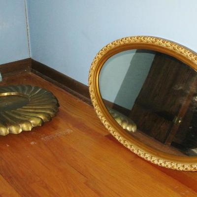 plant stand and oval mirror