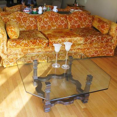 orange couches, there are 2 and a large square glass top coffee table