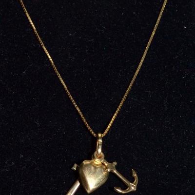Gold necklace with anchor, heart and cross