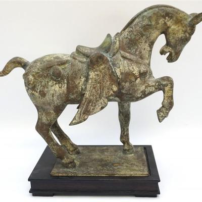 Chinese Tang Dynasty-manner patinated heavy bronze figure of a prancing horse. With applied encrustation and surface wear to suggest age....