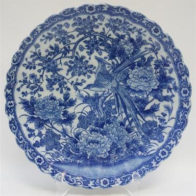 Japanese Blue and White Porcelain Charger. 19th c., with scalloped rim, decorated with a floral scroll border enclosing a large central...