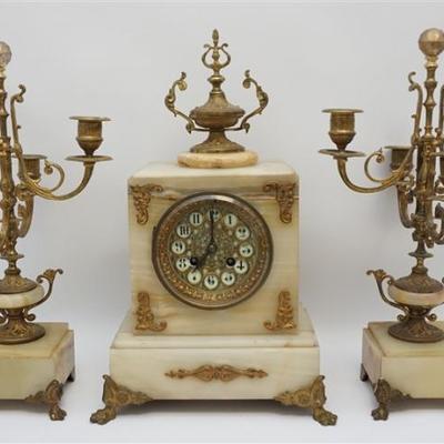 Antique Late 19th, early 20th c. French Onyx Clock with Candelabra Garniture. Clock with gilded ormolu accents on paw feet, urn finial....