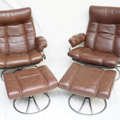 Pair of Ekornes Stressless Mid Century Modern Leather Chairs and Matching Ottomans. They both feature chrome swivel base and leather...