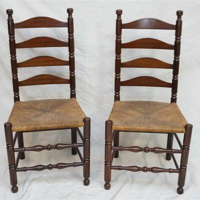 Two Good Quality 20th c. Dark Walnut Ladder Back Chairs with Rush Seats.  Each measures 20
