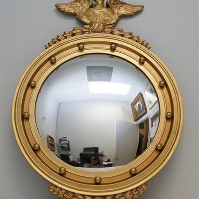Vintage 20th c. Federal Style Bulls Eye Mirror. Gilt Wood and Gesso with Carved Eagle. Good condition, peeling flake to front. Measures...