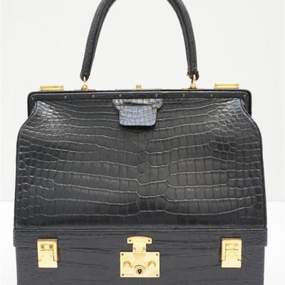 Vintage Hermes Sac Mallet Travel Case with Gold Hardware. Shiny Crocodile Porosus Leather in color Noir. This bag features a rolled...