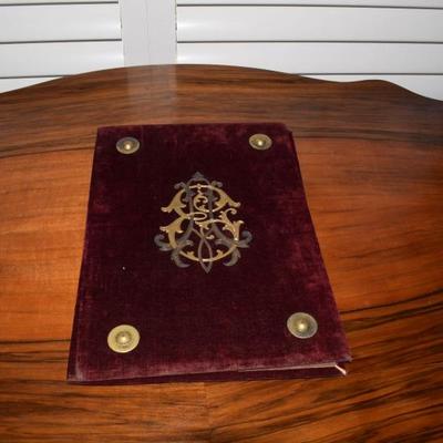 This is a velvet covered mat that folds out flat. There are four brass feet. It is blank inside. I have no idea what it is. It looks like...